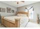 Cozy bedroom with a large wooden bed, plush rug, and soft natural light from the window at 636 Milan Dr, Kissimmee, FL 34758