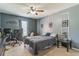 Comfortable bedroom with neutral gray walls, ceiling fan, and a desk, perfect for relaxation at 636 Milan Dr, Kissimmee, FL 34758