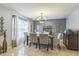 Inviting dining room features neutral decor, modern chandelier, and bright natural light at 636 Milan Dr, Kissimmee, FL 34758