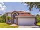 Charming two-story home featuring a two-car garage, manicured lawn, and inviting front entrance at 636 Milan Dr, Kissimmee, FL 34758