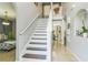 Bright foyer features tile flooring, staircase, and an arched alcove with decorative accents at 636 Milan Dr, Kissimmee, FL 34758