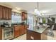 Cozy kitchen featuring cherry cabinets, granite countertops, a tile backsplash, and stainless steel appliances at 636 Milan Dr, Kissimmee, FL 34758