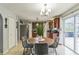 Open-concept kitchen and dining area with stainless steel appliances and sliding door access to the backyard at 636 Milan Dr, Kissimmee, FL 34758