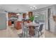Lovely kitchen and dining area with cherry cabinets, stainless appliances, and sliding glass doors to the pool at 636 Milan Dr, Kissimmee, FL 34758