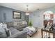Comfortable living room with stylish gray sectional, patterned ottoman, and decorative lighting at 636 Milan Dr, Kissimmee, FL 34758
