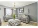 Cozy living room with gray walls, tile floors, stylish furniture, and bright natural light at 636 Milan Dr, Kissimmee, FL 34758