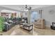 Open living space featuring tile floors, a ceiling fan, and a view into the kitchen area at 636 Milan Dr, Kissimmee, FL 34758