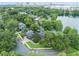 Stunning aerial view of lakefront homes surrounded by lush trees and a glimpse of the city skyline at 640 S Lake Formosa Dr, Orlando, FL 32803