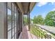 Charming balcony with decorative railing and views of the street and trees at 640 S Lake Formosa Dr, Orlando, FL 32803