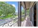 Charming balcony with decorative railing and views of the street and trees at 640 S Lake Formosa Dr, Orlando, FL 32803