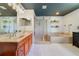 Bright bathroom with double sinks, a shower, and a bathtub with shelves for plants at 640 S Lake Formosa Dr, Orlando, FL 32803