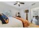Bright bedroom features a four-poster bed, television and a window letting in natural light at 640 S Lake Formosa Dr, Orlando, FL 32803