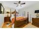 Inviting bedroom with four-poster bed, stylish decor, and natural light from the window at 640 S Lake Formosa Dr, Orlando, FL 32803