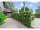 Brick paved driveway featuring verdant landscaping, charming shrubbery, and a glimpse of an exterior gate at 640 S Lake Formosa Dr, Orlando, FL 32803
