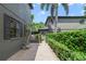Brick paved walkway with decorative foliage, mature shade trees, and a glimpse of the rear patio at 640 S Lake Formosa Dr, Orlando, FL 32803