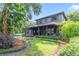 Landscaped home exterior with lush garden beds and manicured lawn and covered porch at 640 S Lake Formosa Dr, Orlando, FL 32803