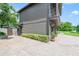 Well-manicured exterior featuring brick paving, mature trees, and a view of the neighboring lake at 640 S Lake Formosa Dr, Orlando, FL 32803