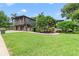 Expansive front yard with lush green lawn and mature trees framing the two-story house at 640 S Lake Formosa Dr, Orlando, FL 32803