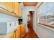 Hallway leading to an office space featuring custom wood cabinets and hardwood floors at 640 S Lake Formosa Dr, Orlando, FL 32803