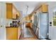 Bright kitchen featuring stainless steel appliances, wood cabinets, and modern lighting at 640 S Lake Formosa Dr, Orlando, FL 32803