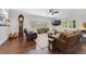 Spacious living room with hardwood floors, plantation shutters, and a decorative grandfather clock at 640 S Lake Formosa Dr, Orlando, FL 32803