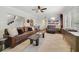 Comfortable living room with hardwood floors and plush furniture, adjacent to stairs and dining area at 640 S Lake Formosa Dr, Orlando, FL 32803