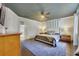Spacious main bedroom featuring a ceiling fan, wood floors and a blue rug at 640 S Lake Formosa Dr, Orlando, FL 32803