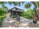 Charming brick patio featuring an outdoor dining set, surrounded by lush landscaping and greenery at 640 S Lake Formosa Dr, Orlando, FL 32803