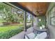 Inviting porch with wood ceiling and posts, fan, and seating, overlooking lush greenery at 640 S Lake Formosa Dr, Orlando, FL 32803