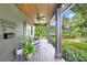 Covered porch features wood ceiling and posts, fan, and green plantings at 640 S Lake Formosa Dr, Orlando, FL 32803
