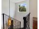 Elegant staircase with dark railings and treads, illuminated by an ornate hanging light fixture at 640 S Lake Formosa Dr, Orlando, FL 32803