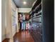 Walk-in closet featuring custom shelving, drawer storage and hardwood floors at 640 S Lake Formosa Dr, Orlando, FL 32803