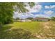 Large backyard features ample green space, perfect for outdoor activities and gatherings at 6401 Fortune Ln, Apopka, FL 32712