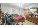 Bedroom featuring desk, chair, dresser and red plaid bedspread at 6401 Fortune Ln, Apopka, FL 32712