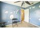 Bedroom featuring blue walls, ceiling fan, and open doorway at 6401 Fortune Ln, Apopka, FL 32712
