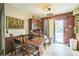 View of dining room with table and hutch and sliding glass door to backyard at 6401 Fortune Ln, Apopka, FL 32712