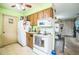 View of kitchen with appliances and a glimpse into the living room at 6401 Fortune Ln, Apopka, FL 32712