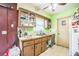View of kitchen with cabinets, sink, countertops, and door to the outside at 6401 Fortune Ln, Apopka, FL 32712