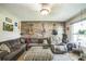 Spacious living room featuring a large sectional, accent wall, and natural light at 6401 Fortune Ln, Apopka, FL 32712
