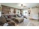 Comfortable living room with large sofa, accent wall, and natural light at 6401 Fortune Ln, Apopka, FL 32712