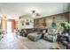 Cozy living room with a large sectional sofa, wood accent wall, and unique guitar decorations at 6401 Fortune Ln, Apopka, FL 32712