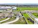 An aerial shot presents two homes with well-kept lawns, showcasing their driveways and the neighborhood's playground area at 785 Orchid Grove Blvd, Davenport, FL 33837