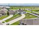 A bird's-eye view of two single-Gathering homes showcasing their driveways, lawns, and proximity to neighborhood amenities at 785 Orchid Grove Blvd, Davenport, FL 33837