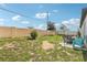 Spacious backyard featuring a patio with seating, grass, and a privacy fence at 785 Orchid Grove Blvd, Davenport, FL 33837
