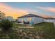 Spacious backyard patio area with outdoor furniture and string lights at dusk at 785 Orchid Grove Blvd, Davenport, FL 33837
