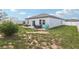 A view of the home's backyard, showing the patio and spacious lawn at 785 Orchid Grove Blvd, Davenport, FL 33837