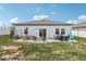 Cozy backyard featuring a patio with outdoor seating and an attached home at 785 Orchid Grove Blvd, Davenport, FL 33837