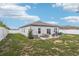 The backyard featuring a well-maintained lawn and cozy patio with outdoor seating at 785 Orchid Grove Blvd, Davenport, FL 33837