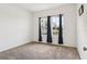 Bright bedroom featuring neutral carpet, a large window with curtains and white walls at 785 Orchid Grove Blvd, Davenport, FL 33837