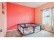 Bright bedroom featuring neutral carpet, an accent wall and a playpen at 785 Orchid Grove Blvd, Davenport, FL 33837
